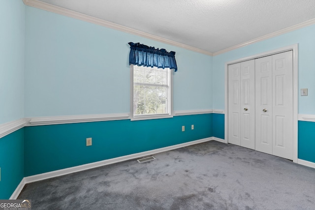 873 Austin Rd, Newnan, GA 30263 - unfurnished bedroom with ornamental molding, a textured ceiling, carpet, a closet, and baseboards