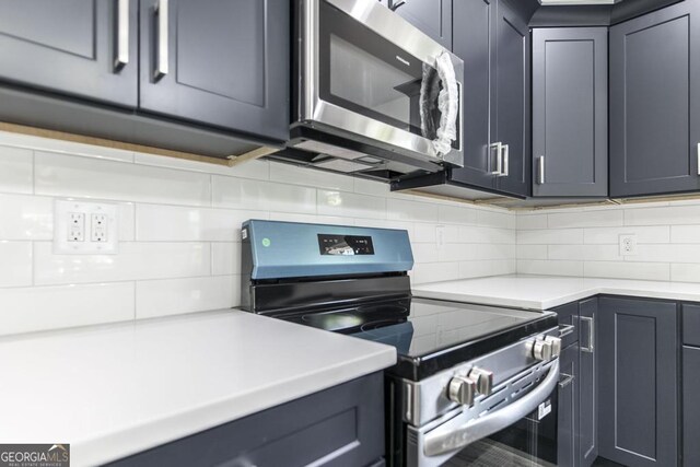 2349 Berthadale Ave, Macon, GA 31204 - kitchen with light countertops, appliances with stainless steel finishes, gray cabinets, and backsplash