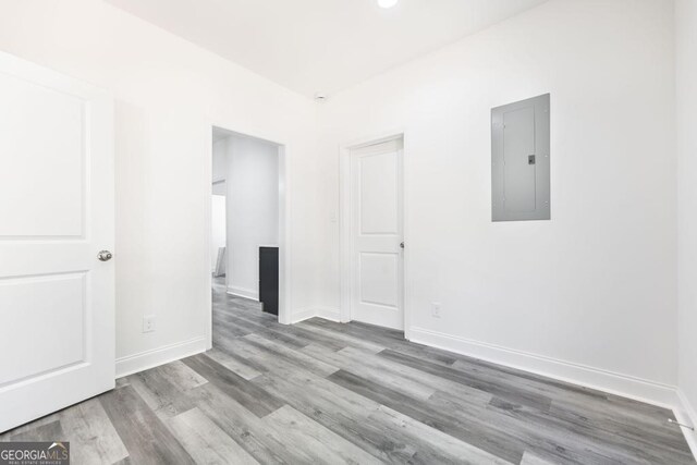 2349 Berthadale Ave, Macon, GA 31204 - empty room with baseboards, electric panel, and wood finished floors
