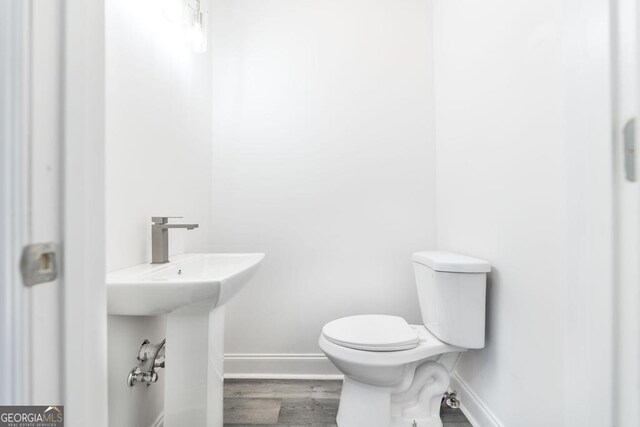 2349 Berthadale Ave, Macon, GA 31204 - half bathroom with toilet, baseboards, and wood finished floors