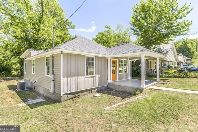 2349 Berthadale Ave, Macon, GA 31204 - back of property featuring cooling unit, a shingled roof, a porch, and a lawn