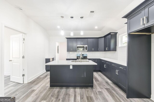 2349 Berthadale Ave, Macon, GA 31204 - kitchen featuring backsplash, light countertops, stainless steel appliances, and light wood-style flooring