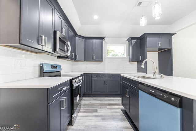 2349 Berthadale Ave, Macon, GA 31204 - kitchen with stainless steel appliances, visible vents, a sink, light countertops, and light wood-type flooring