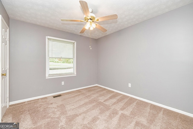 unfurnished bedroom featuring carpet, visible vents, baseboards, and ceiling fan