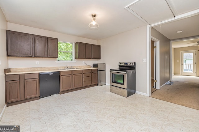 kitchen featuring a healthy amount of sunlight, light countertops, appliances with stainless steel finishes, and a sink