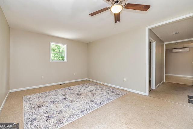 carpeted empty room with ceiling fan, baseboards, and a wall unit AC