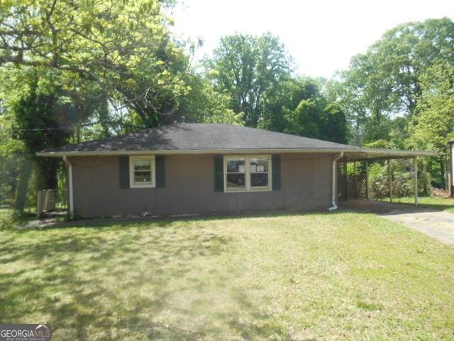 view of home's exterior featuring a yard, driveway, and an attached carport