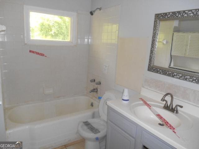 bathroom with toilet, vanity, and shower / bathing tub combination