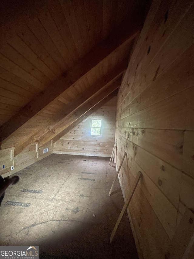 bonus room with vaulted ceiling, wood walls, and wood ceiling