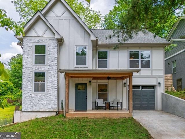 82 Dearborn St SE, Atlanta, GA 30317 - tudor home featuring board and batten siding, concrete driveway, a garage, a front yard, and a porch
