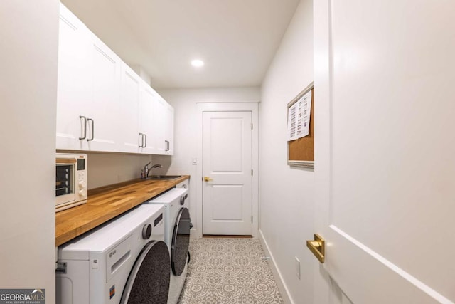 82 Dearborn St SE, Atlanta, GA 30317 - washroom featuring separate washer and dryer, cabinet space, baseboards, recessed lighting, and light tile patterned floors