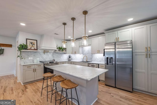 82 Dearborn St SE, Atlanta, GA 30317 - kitchen with appliances with stainless steel finishes, custom range hood, a sink, open shelves, and a kitchen bar