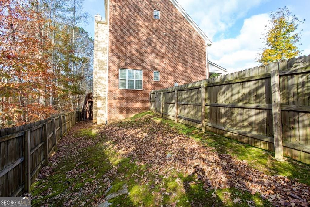 345 Manning Ct, South Fulton, GA 30349 - view of side of property with brick siding and a fenced backyard