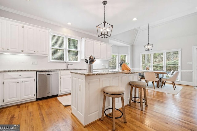 kitchen featuring dishwasher, decorative backsplash, white cabinets, ornamental molding, and vaulted ceiling