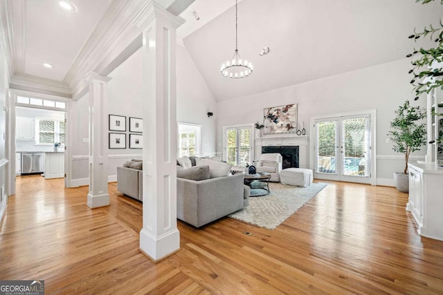 250 Chason Wood Way, Roswell, GA 30076 - living area with ornate columns, high vaulted ceiling, light wood-type flooring, a premium fireplace, and a chandelier