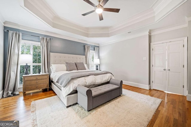 250 Chason Wood Way, Roswell, GA 30076 - bedroom featuring a raised ceiling, crown molding, wood finished floors, and ceiling fan