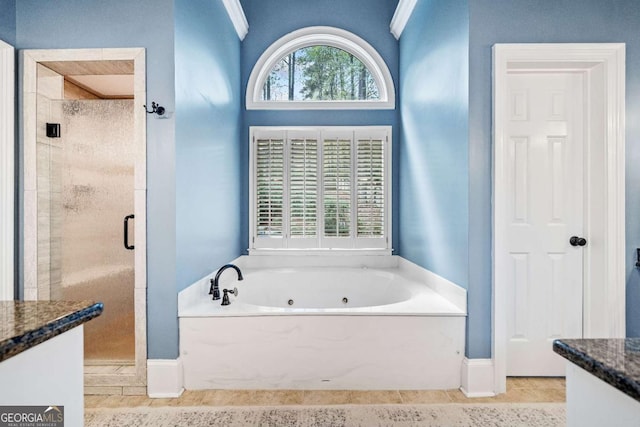 full bathroom with vanity, a shower stall, a tub with jets, and tile patterned flooring
