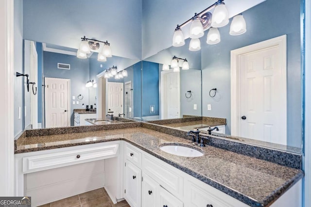 bathroom with tile patterned floors and vanity