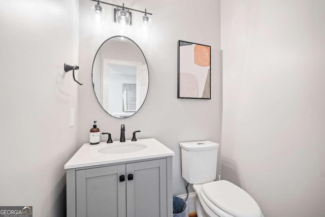 bathroom featuring toilet and vanity