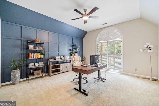 office with vaulted ceiling, a decorative wall, a ceiling fan, carpet flooring, and baseboards