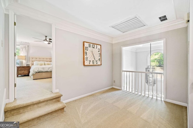 hall featuring carpet, ornamental molding, and baseboards