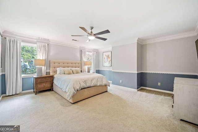 bedroom featuring crown molding, multiple windows, carpet, baseboards, and a ceiling fan