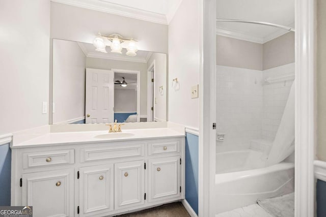 ensuite bathroom with ornamental molding, vanity, and washtub / shower combination
