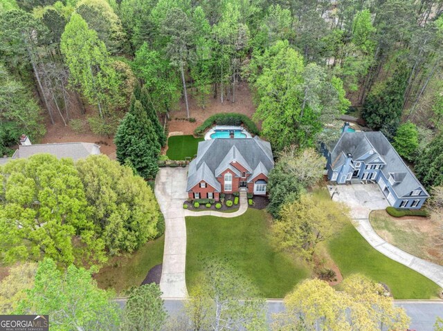 view of subject property with a forest