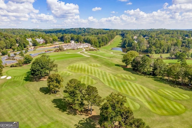 aerial view of a nearby body of water, a heavily wooded area, and a local golf course