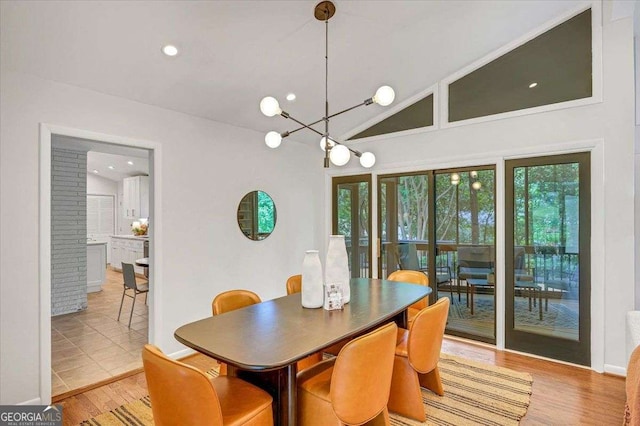 dining area with lofted ceiling, a chandelier, light wood-type flooring, and recessed lighting