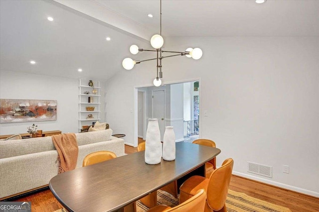 dining space featuring wood finished floors, recessed lighting, baseboards, built in shelves, and a chandelier