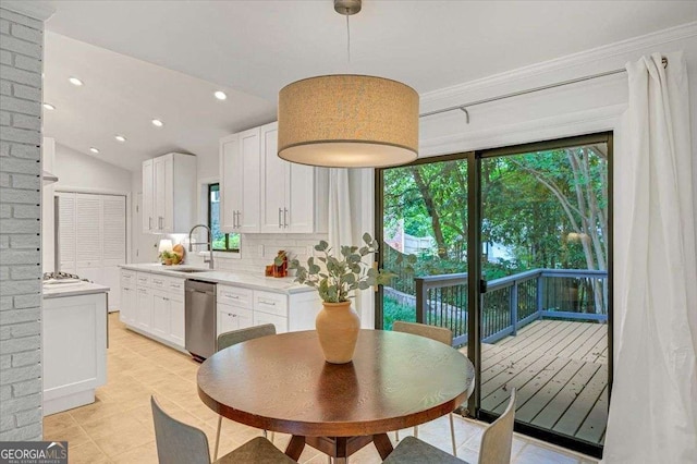 kitchen with a sink, light countertops, white cabinetry, appliances with stainless steel finishes, and tasteful backsplash