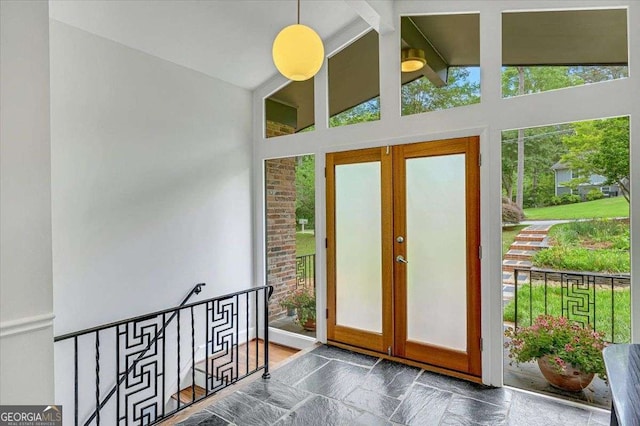 entryway with stone finish flooring and french doors