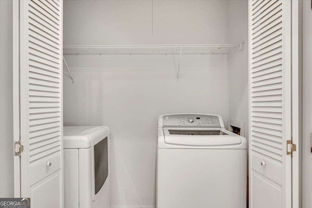clothes washing area with washer and dryer