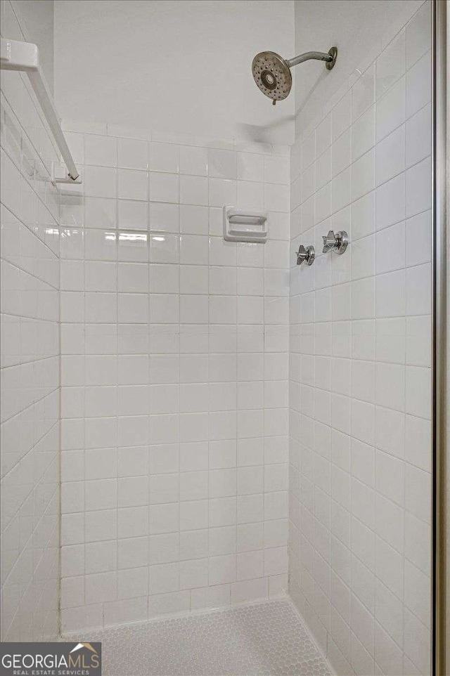 bathroom with a tile shower
