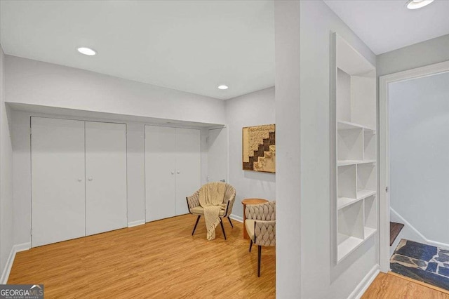 living area with wood finished floors, baseboards, and recessed lighting