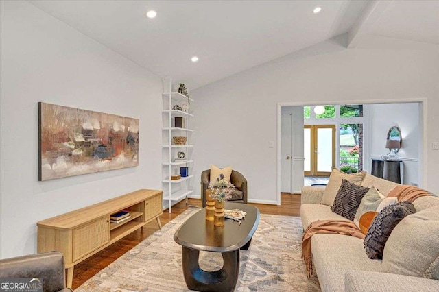 living room with wood finished floors, beamed ceiling, recessed lighting, baseboards, and high vaulted ceiling
