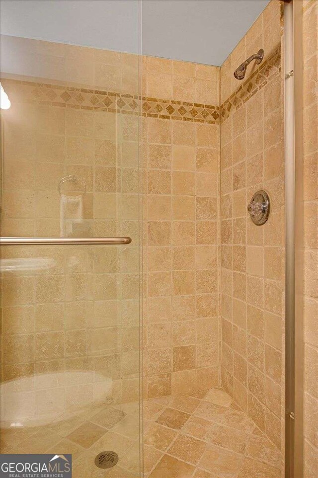 full bath with a shower stall