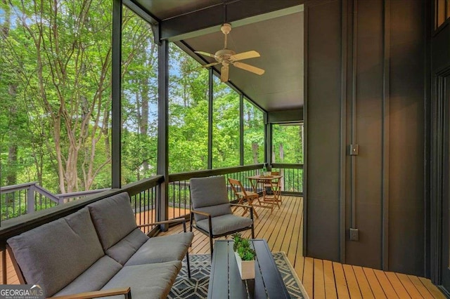 sunroom / solarium featuring ceiling fan and an outdoor living space