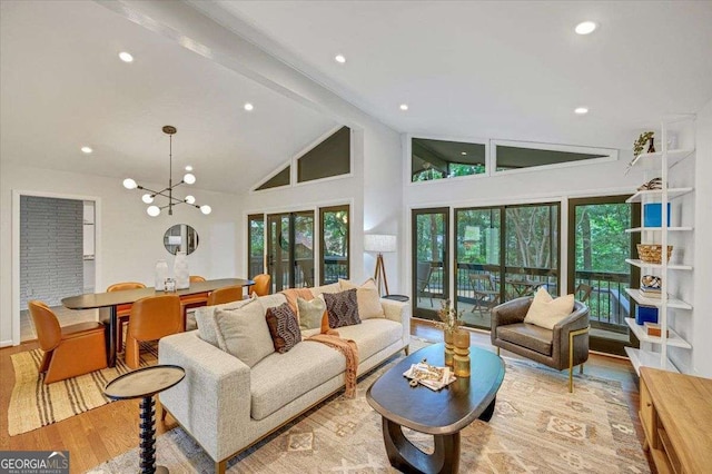 living room featuring wood finished floors, plenty of natural light, high vaulted ceiling, recessed lighting, and a chandelier