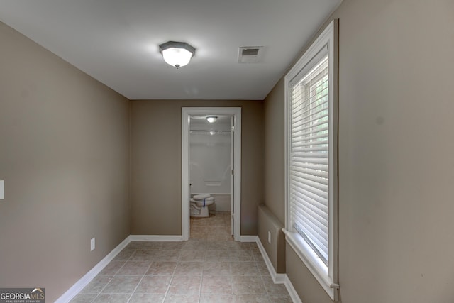 135 Magnolia Dr, Oxford, GA 30054 - hallway with light tile patterned floors, visible vents, and baseboards