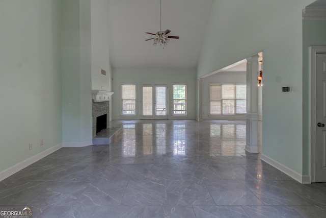 135 Magnolia Dr, Oxford, GA 30054 - unfurnished living room with high vaulted ceiling, decorative columns, baseboards, ceiling fan, and marble finish floor