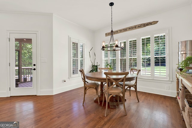 dining space featuring a chandelier, dark wood finished floors, baseboards, healthy amount of natural light, and ornamental molding