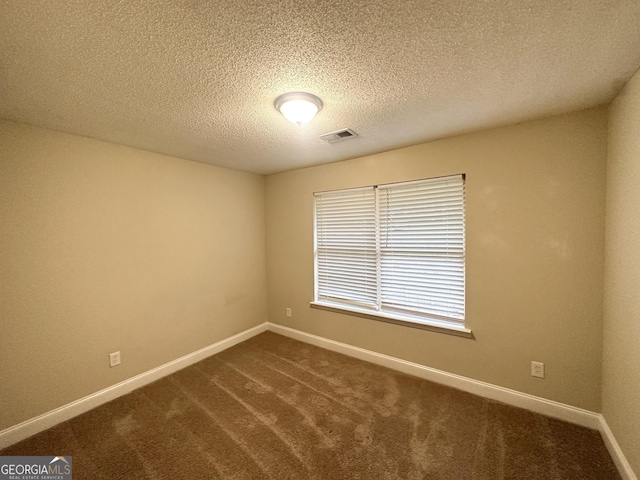 221 Courthouse Park Dr, Temple, GA 30179 - unfurnished room with baseboards, dark colored carpet, visible vents, and a textured ceiling