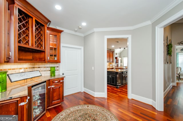 1340 Traditions Way, Jefferson, GA 30549 - bar area featuring wine cooler, crown molding, dark wood-type flooring, decorative backsplash, and baseboards