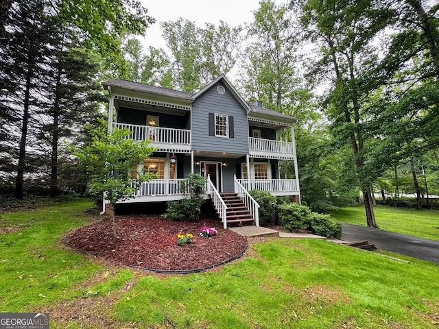 5307 Red Rock Trce, Powder Springs, GA 30127 - view of front facade featuring a porch, a balcony, a front yard, and asphalt driveway