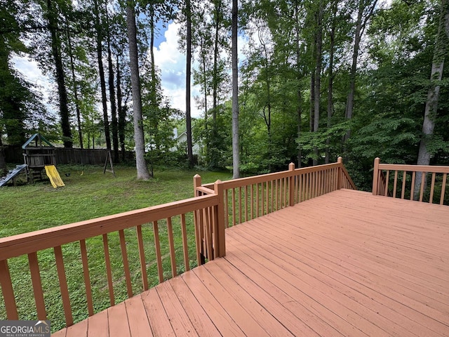 deck featuring a yard and a playground