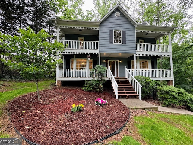 view of front facade with a balcony and covered porch