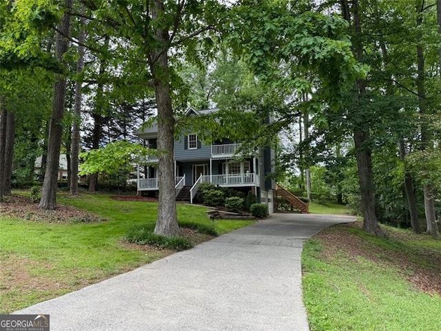 5307 Red Rock Trce, Powder Springs, GA 30127 - view of front of house with covered porch, driveway, a front yard, and stairway