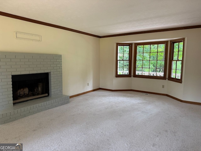unfurnished living room featuring carpet, ornamental molding, baseboards, and a fireplace